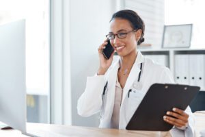 Doctor making a call on a mobile phone.